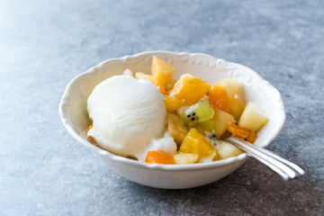 Fruit Salad with Vanilla Ice Cream in Ceramic Bowl.