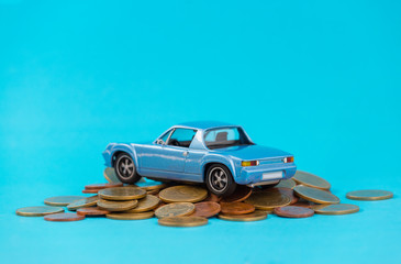 Classic of model blue toy car park on stack golden coins. Saving, Financial and Installment payment concept.