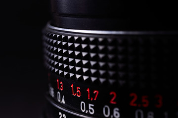 Vintage lens scale signs closeup. Stock photo with blurred gray background.