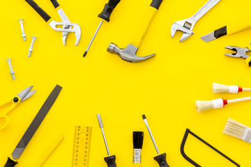 building, painting and repair tools for house constructor work place set yellow background top view space for text
