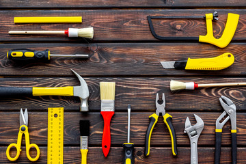 building, painting and repair tools for house constructor work place set wooden background top view pattern