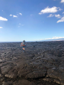 Man hiking in volcanic landscape, Puna Coast Trail, Hawaii Volcanoes National Park, Hawaii Islands, USA