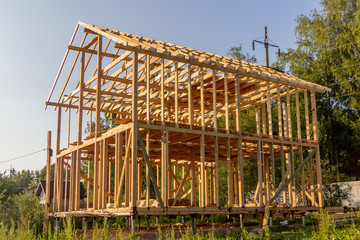 wooden interior frame of a new house under building, architectural residential construction stick built home framework.