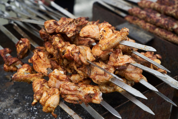 Roasted chicken wings meat kebab on skewers, close-up
