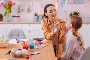 Beautiful young female being at home with her daughter