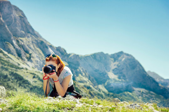 Young woman photographing in mountains