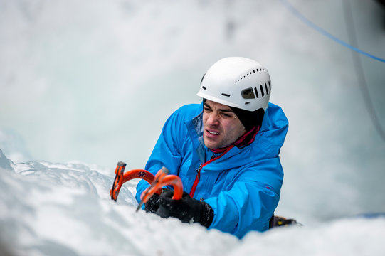 Man lead climbing an ice fall in Simplon Pass, Valais, Switzerland.