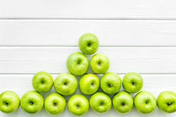 green apples for organic summer food pattern on light wooden background top view mockup