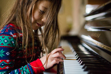 Young girl playing piano
