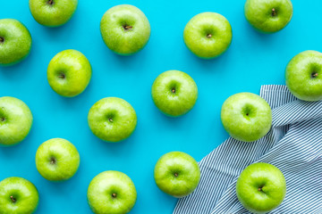 summer food with apples on blue background top view pattern