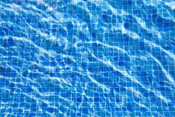 water ripples in swimming pool, blue background