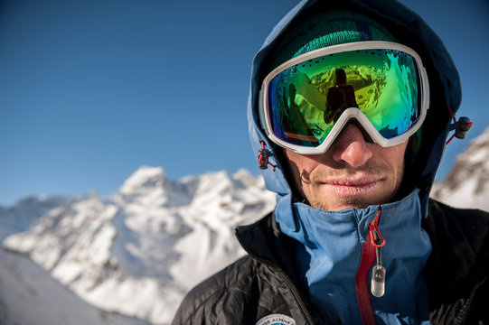 Portrait of an italian Alpine Guide with ski goggles taken during a ski tour on the Alps above Devero. Baceno, Ossola, Italy.