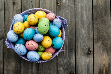 Closeup of colorful easter eggs collected in a bucket, season holiday concept