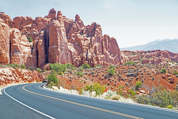 A road past beautiful spires and towers in Arches National Park.