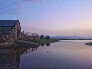 Fototapeta premium Scenic view of old irish house against purple sky 