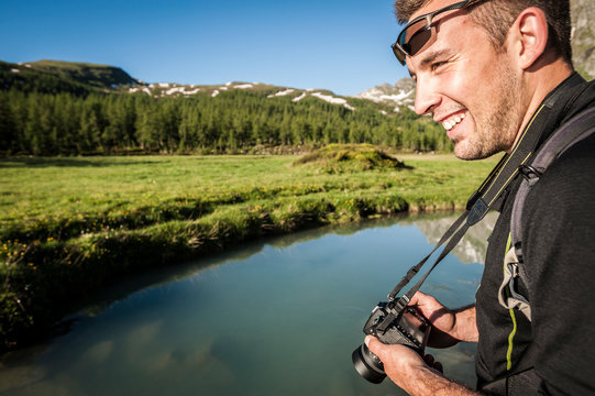 Outdoor photographer enjoys the great environment of Devero National Park. Ossola, Italy.