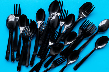 Plastic utilization and the Earth protection concept with flatware on blue background top view pattern