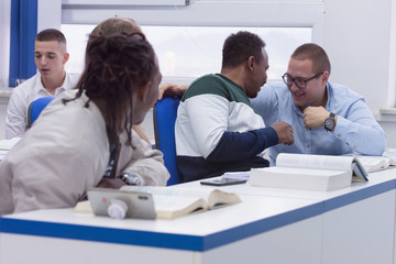 Fototapeta premium University Students during the class. Resolving problems together. Team work concept.