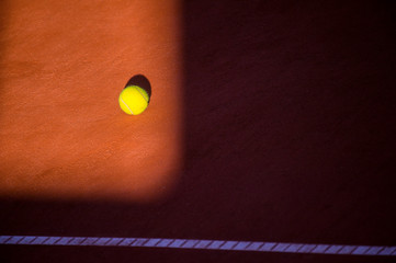 Tennis ball on a clay court