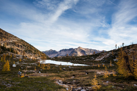 The colorful larch trees and steep mountains of the Cascades in the Pasayten Wilderness on the Pacific Crest Trail (PCT) in Washington.