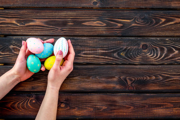 Colorful eggs for easter on wooden background top view mockup