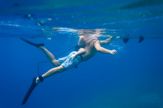 Father and son diving under water,Bali,Indonesia