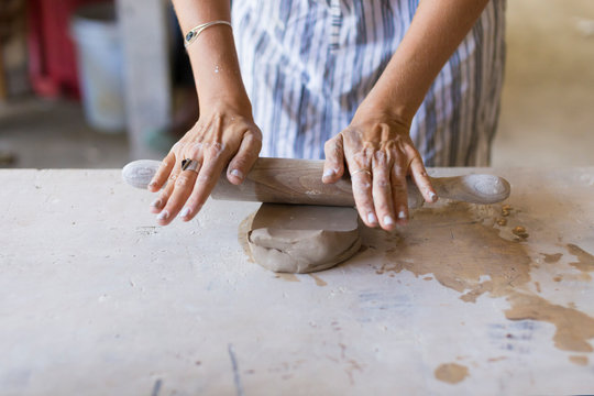 Young woman in ceramic workshop.
