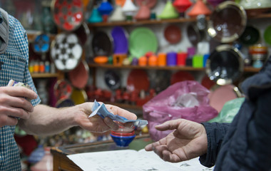 Customer paying for goods in souk, Marrakesh, Morocco
