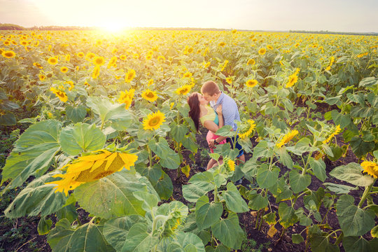 girl and man in a field of sunflowers