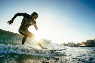 Surfer riding wave on longboard