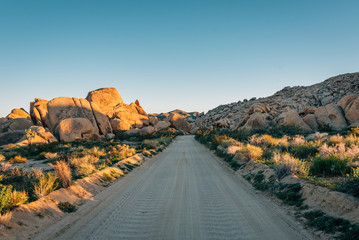 Dirt road and rock piles in the desert, in Joshua Tree National Park, California