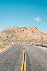 Fototapeta na wymiar Road and mountains in the desert, in Joshua Tree National Park, California