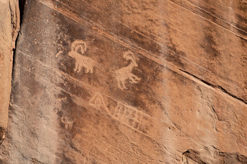 Rock Art scenes carved by the ancients on boulders in Utah.