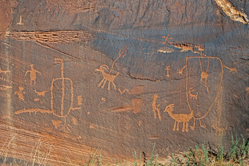 Rock Art scenes carved by the ancients on boulders in Utah.