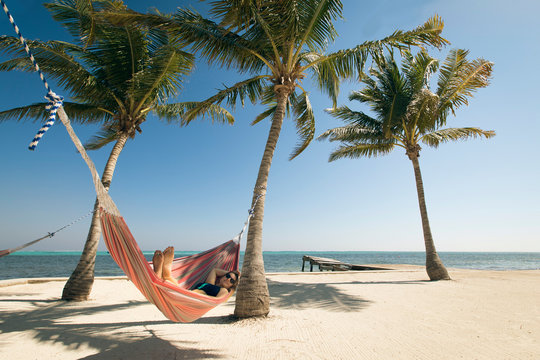 Woman relaxing in hammock - Powered by Adobe
