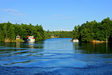 Peace landscape of the Thousand Islands during summer with cottage and boat, Ontario, Canada