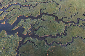 An aerial view of the river delta at Nisqually Wildlife Refuge at low tide at sunset.