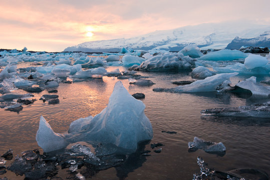 Icebergs float at sunset in Jokulsarlon Glacier Lagoon, Iceland.