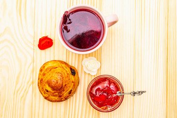 Karkade tea from hibiscus petals (Sudanese rose). Gentle romantic breakfast concept. Buns,...