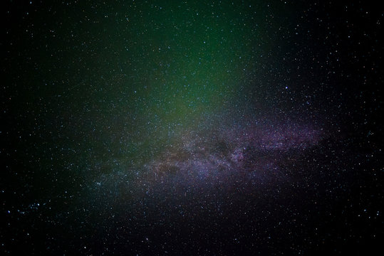 The Aurora Borealis flares briefly over the Milky Way in Iceland.