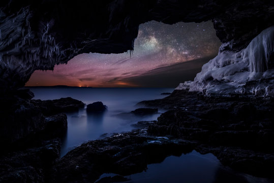Milky way seen from cave with icicles