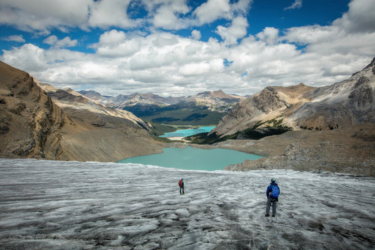 People walking by lake in Bow Glacier, Banff, Alberta, Canada