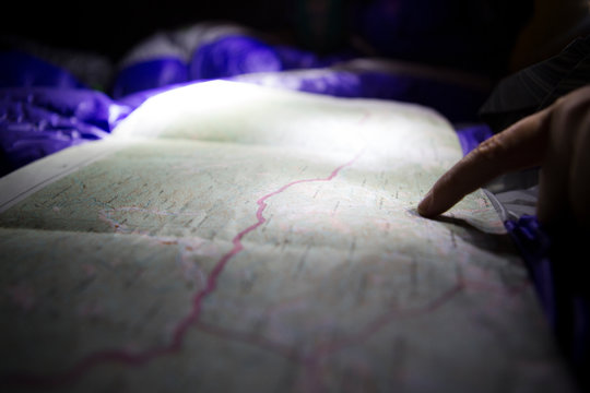 Woman checks the map for logistical planning whilst camping in remote northern Mongolia.