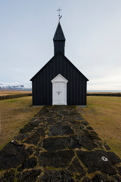 The iconic Budir Black Church of Iceland and the black cobblestone that leads up to it.