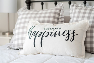 Bedroom decor - "choose happiness" pillow on iron bed