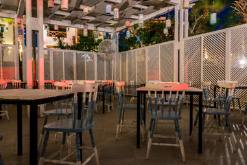 street cafe interior, outdoor wooden tables and chairs
