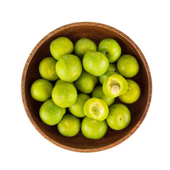 Overhead view of plums in a bowl on white background