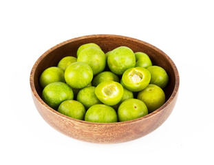plums in a bowl isolated on white background