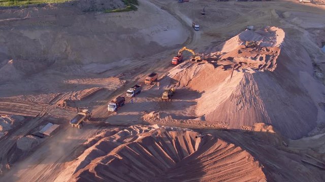 Extraction of construction sand at the quarry. Loading construction sand in trucks.
