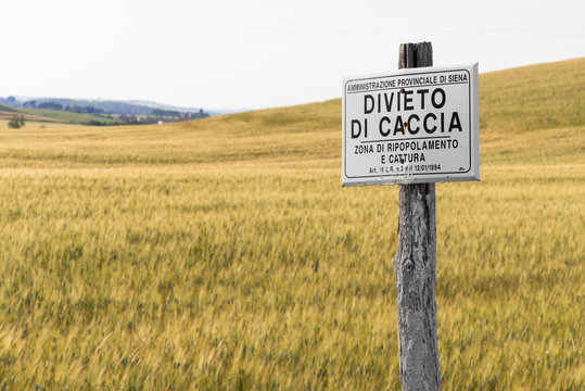 No hunt forbidden sign. Board bans hunting in a field in Tuscany, Italy